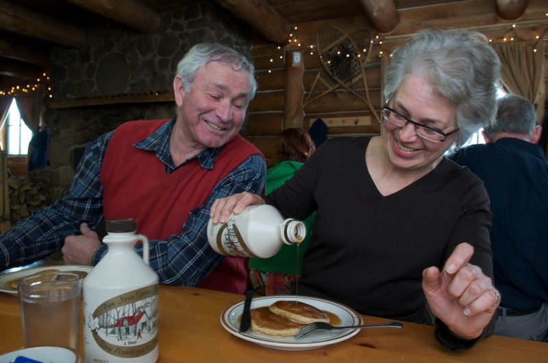 Two people eating breakfast at Sugar Moon Farms.