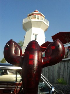 A photo of a lighthouse and lobster statue at Masstown Market