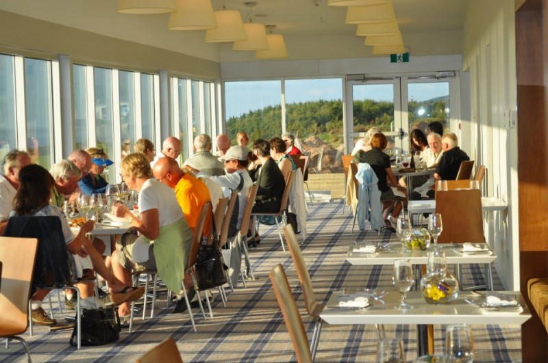 A photo of people dining at Panorama dining room at Cabot Links