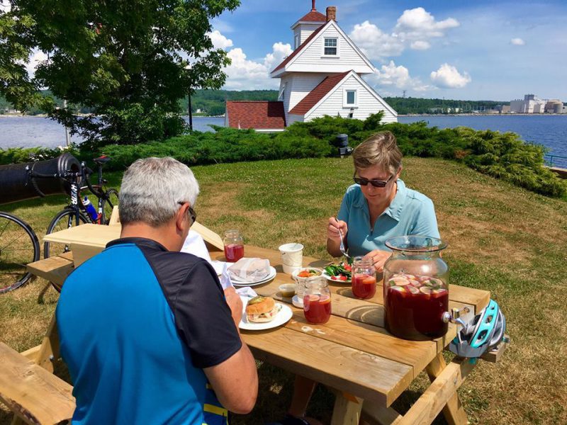 Photo of two people enjoying a picnic at Fort Point Lighthouse by Lane's Privateer Inn