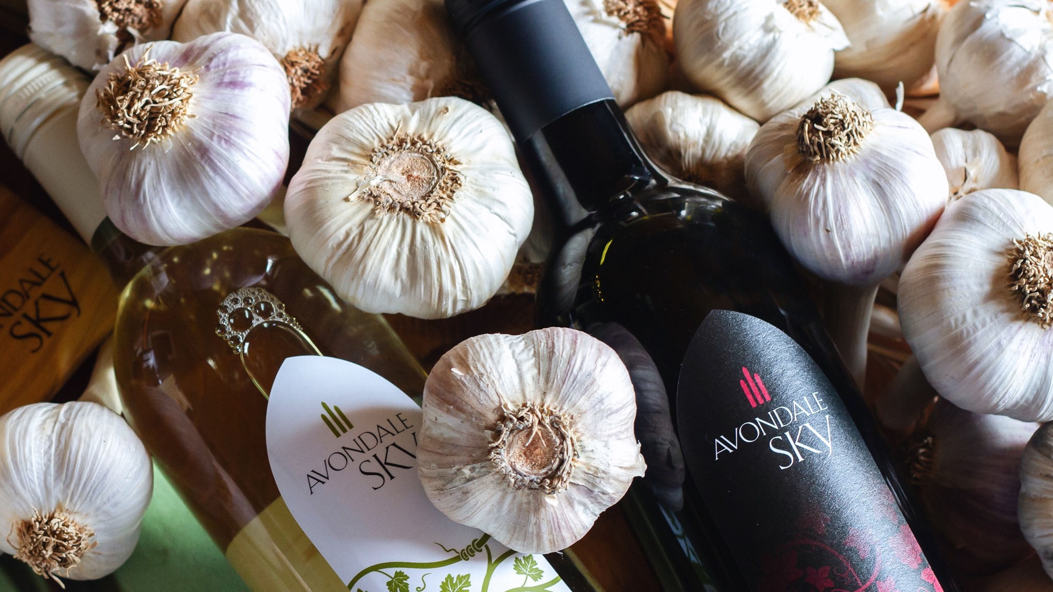 Garlic cloves and avondale sky wine bottles
