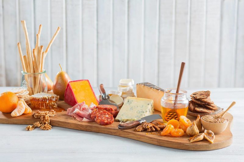 Charcuterie board featuring cornect honey