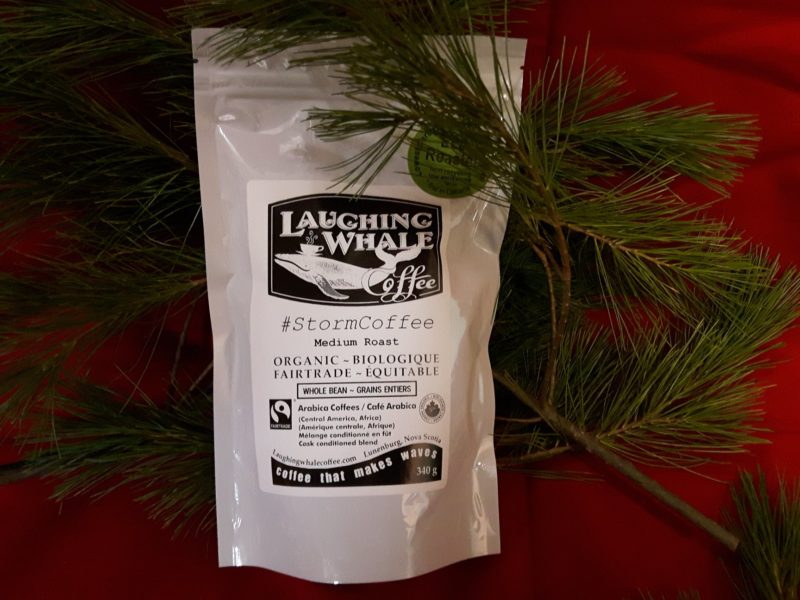 bag of laughing whale storm coffee on red table
