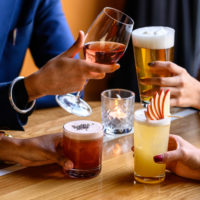 Get Your Hands on Local image of four women holding wine, beer, cider and spirits or cocktails