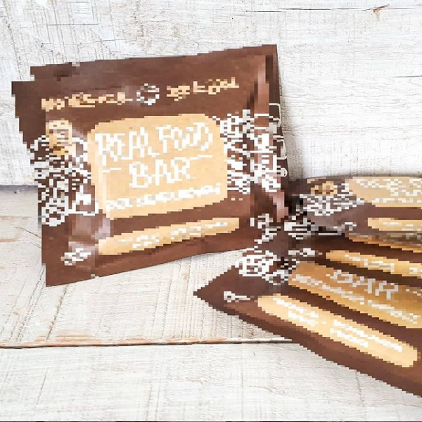 Purposely blurred image of Made with Local's new granola bar. Packaging is brown and beige coloured.
