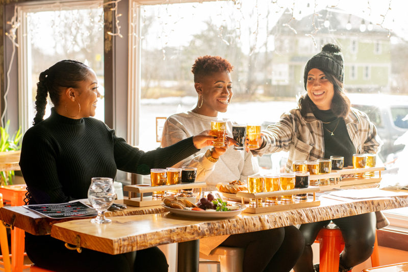 Three women cheers beer samples at Boxing Rock Brewing Company