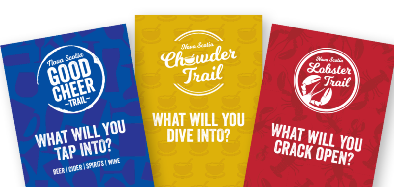 A photo of the covers of the three Culinary Trails passport covers. From left to right, there is the Good Cheer Trail passport (blue cover), the Chowder Trail passport (Gold cover) and the Lobster Trail passport (red cover)