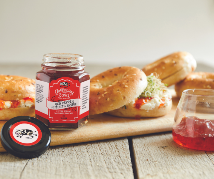 Galloping cows red pepper jelly on a cutting board with bagel sandwiches