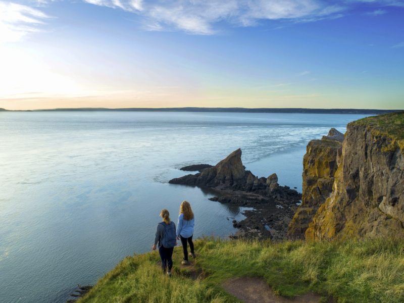 Two girls standing at the edge of Cape Split