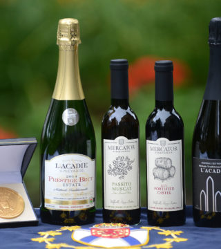 Four wines sit in a row with a medal on the left side