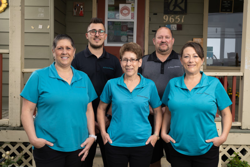 Five people stand in front of La Cuisine Robicheau