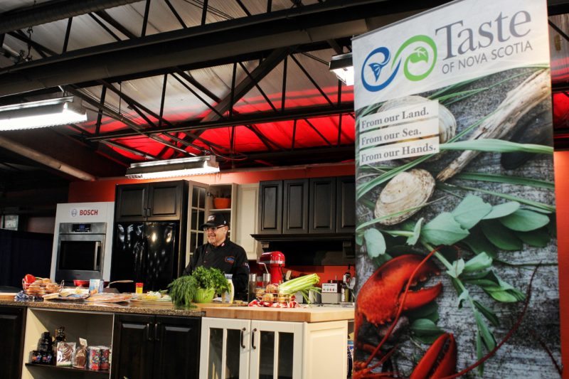 the kilted chef stands on the taste of nova scotia stage at saltscapes
