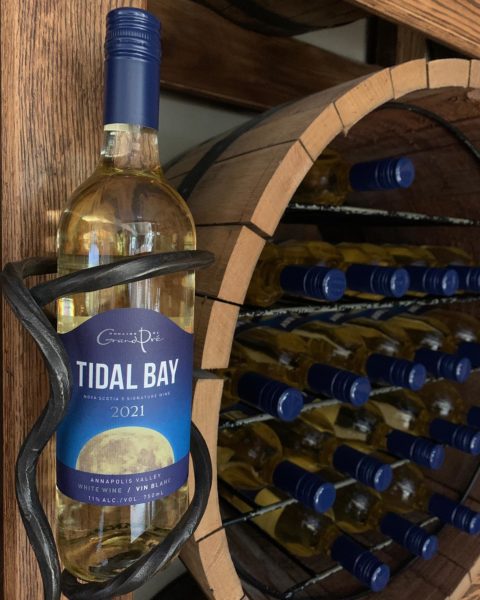 a bottle of grand pre tidal bay sits in a wall hanger
