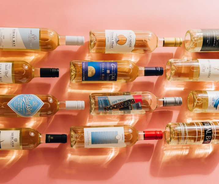 12 tidal bay wine bottles on a pink background