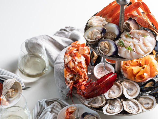 a seafood tower featuring lobster, snow crab, oysters, salmon and more.