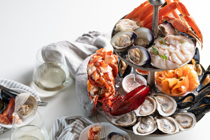 a seafood tower featuring lobster, snow crab, oysters, salmon and more.