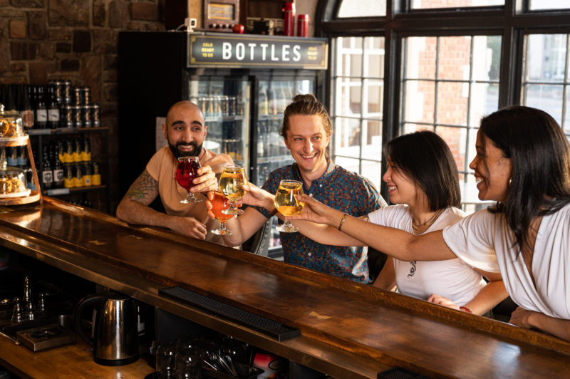 Four people cheers cider at Maritime Express Cider Company