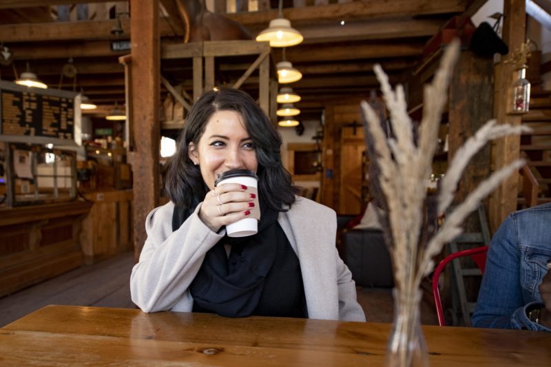someone drinking coffee at the barn