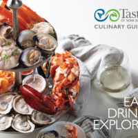 Photo of the cover of the 2022 Culinary Guide, featuring a seafood tower with lobster, shrimp, smoked salmon, oysters and more.
