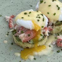 A close-up photo of snow crab and avocado toast, featuring snow crab from Victoria Co-Operative Fisheries Ltd.