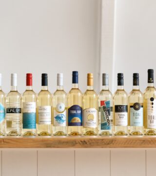 A photo of a collection of bottles of Tidal Bay. The bottles are all lined up on a counter.