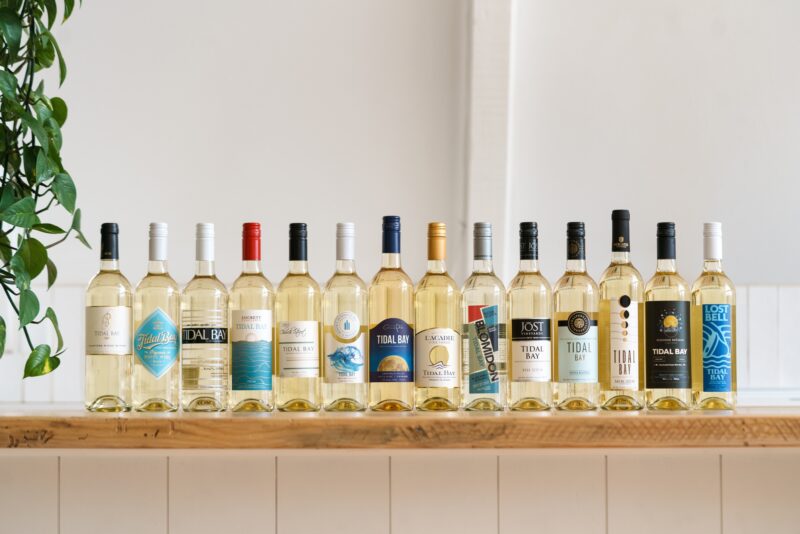 A photo of a collection of bottles of Tidal Bay. The bottles are all lined up on a counter.
