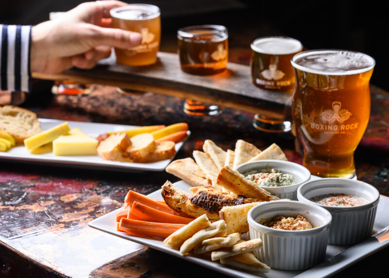 A photo of a flight at Boxing Rock paired with food.