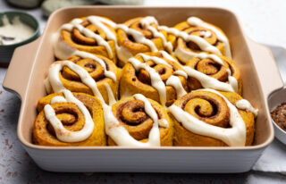 Baking dish of nine cinnamon rolls glazed
